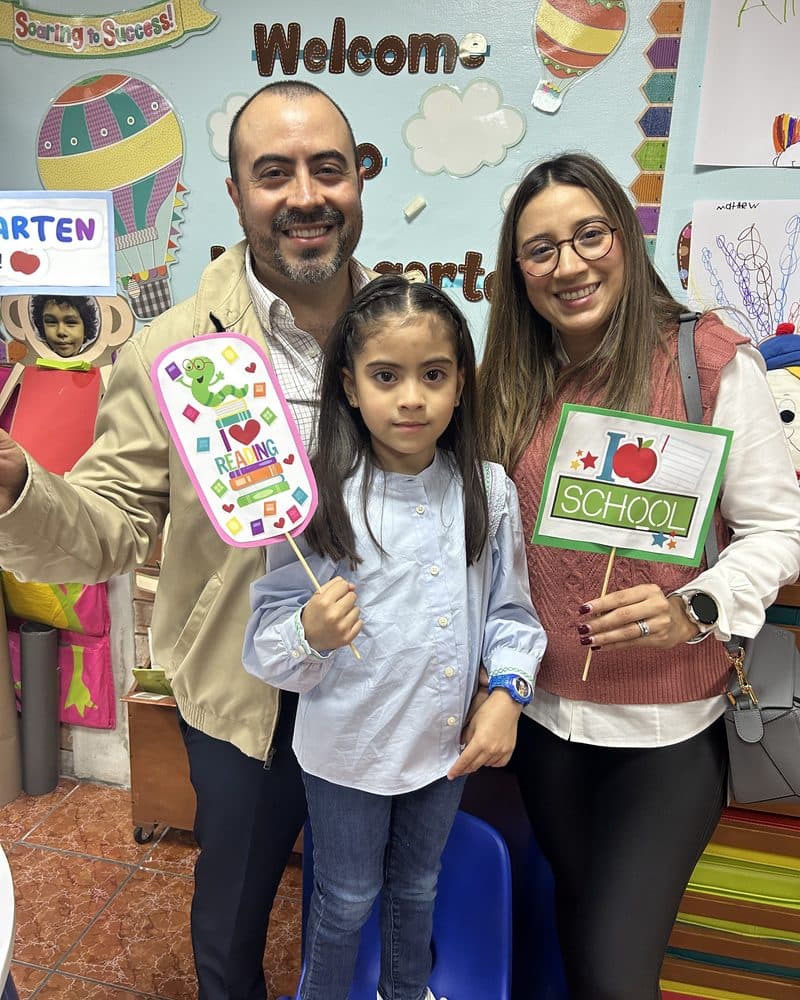 The Moran Pineda family together in a decorated classroom on the first day of school