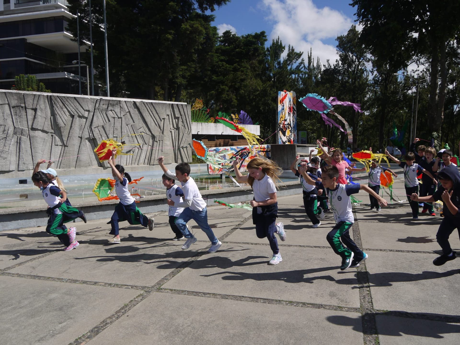 Equity students running with kites on a school outing
