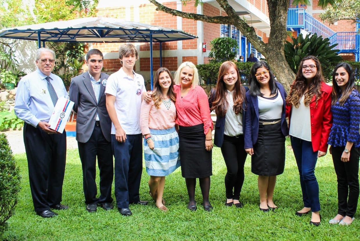 Graduating students and faculty together on the Equity campus lawn
