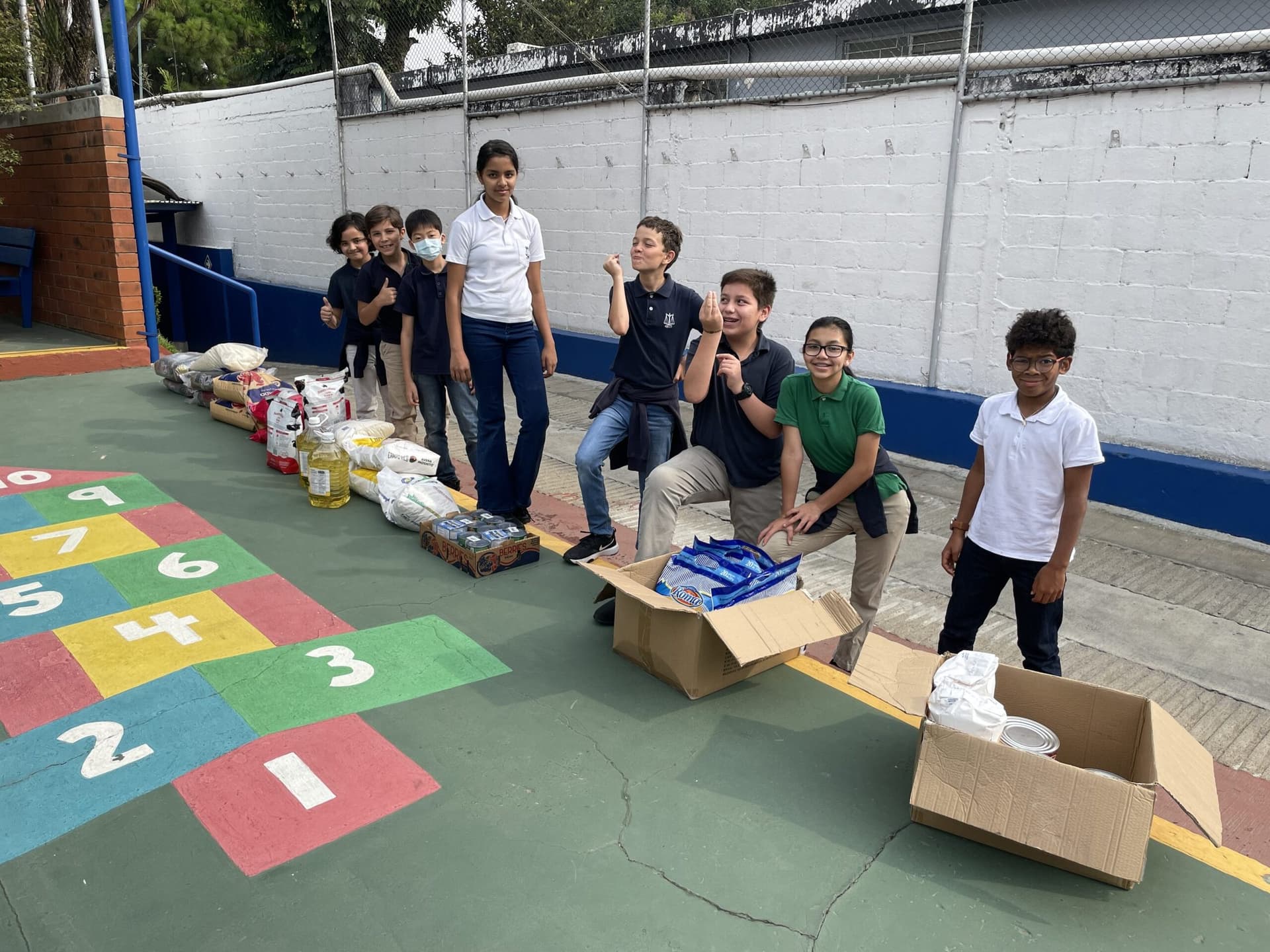 Students gathered around donation boxes during a service project