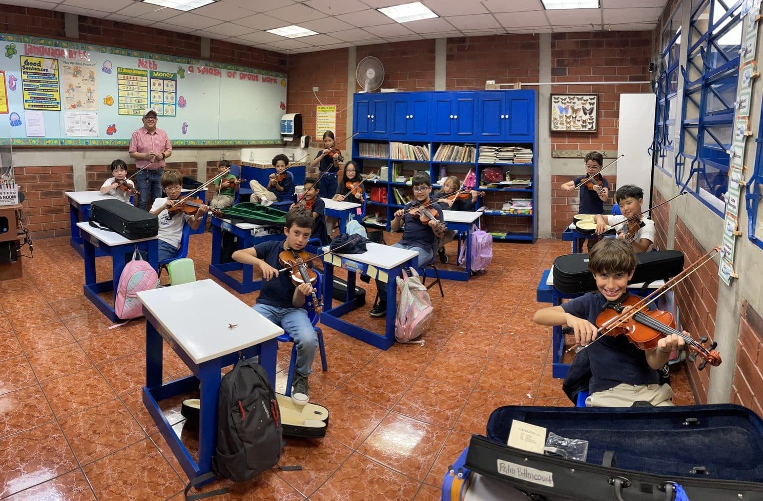 Elementary students at music stands during a classroom string rehearsal